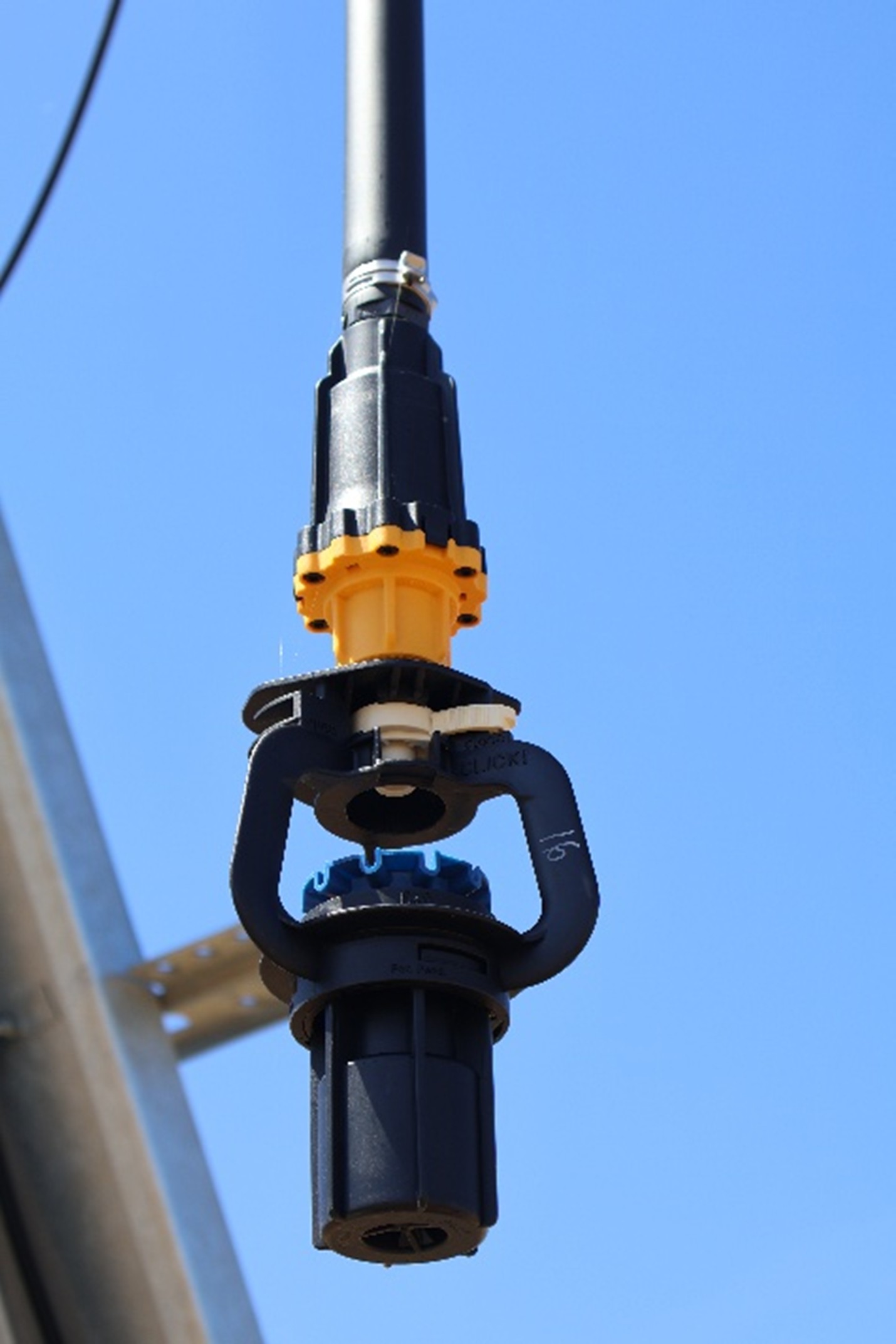 A pressure regulator installed on a sprinkler.